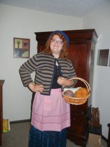 Where worlds collide: Dora (real life) dressed as Mrs. Weasley (for a Potter midnight show) in front of my Narnia wardrobe (and art)