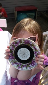 Birthday girl showing off her purple tea saucer. Purple's her FAVORITE.