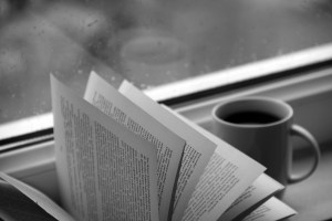 Cup of coffee and book pages- black and white