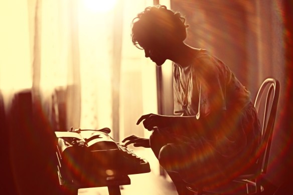 girl typing on a typewriter